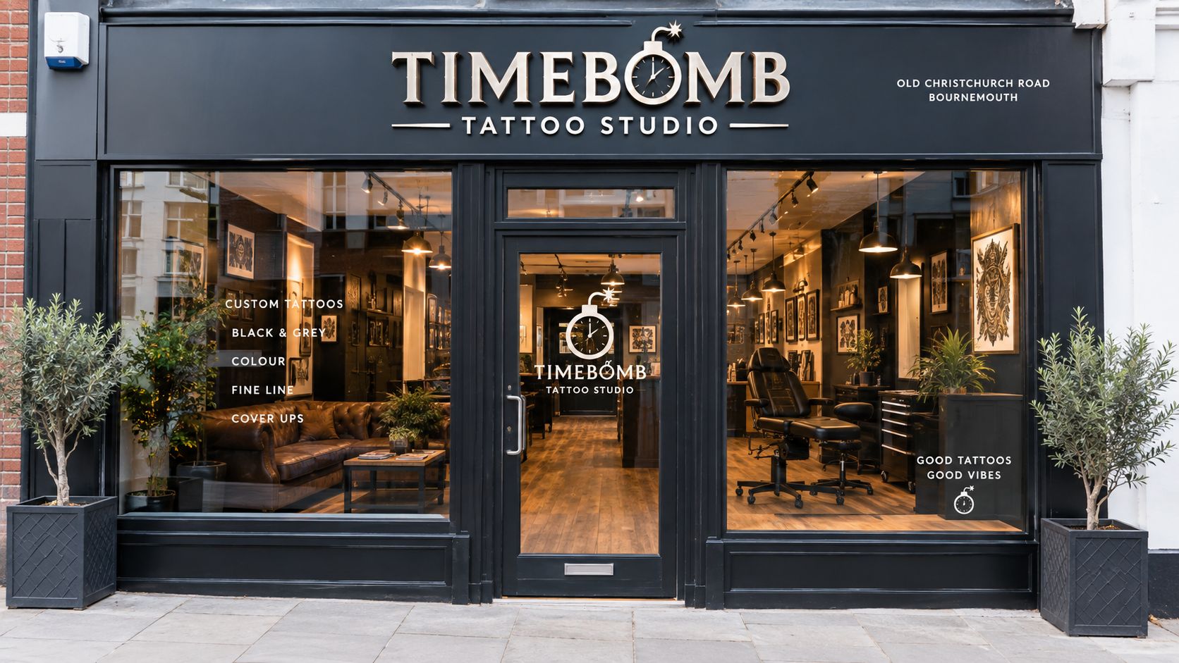 The storefront of Timebomb Tattoo Studio in Bournemouth with a clean, modern black facade and windows.